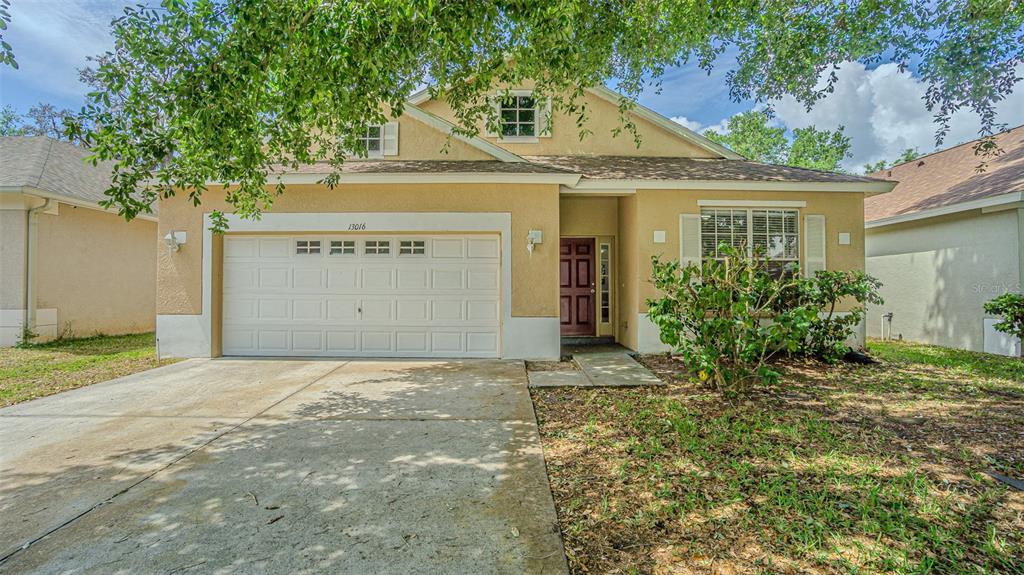 13016 Terrace Brook Place Temple Terrace, FL 33637 - Photo 1 of 27 a front view of a house with a yard and garage