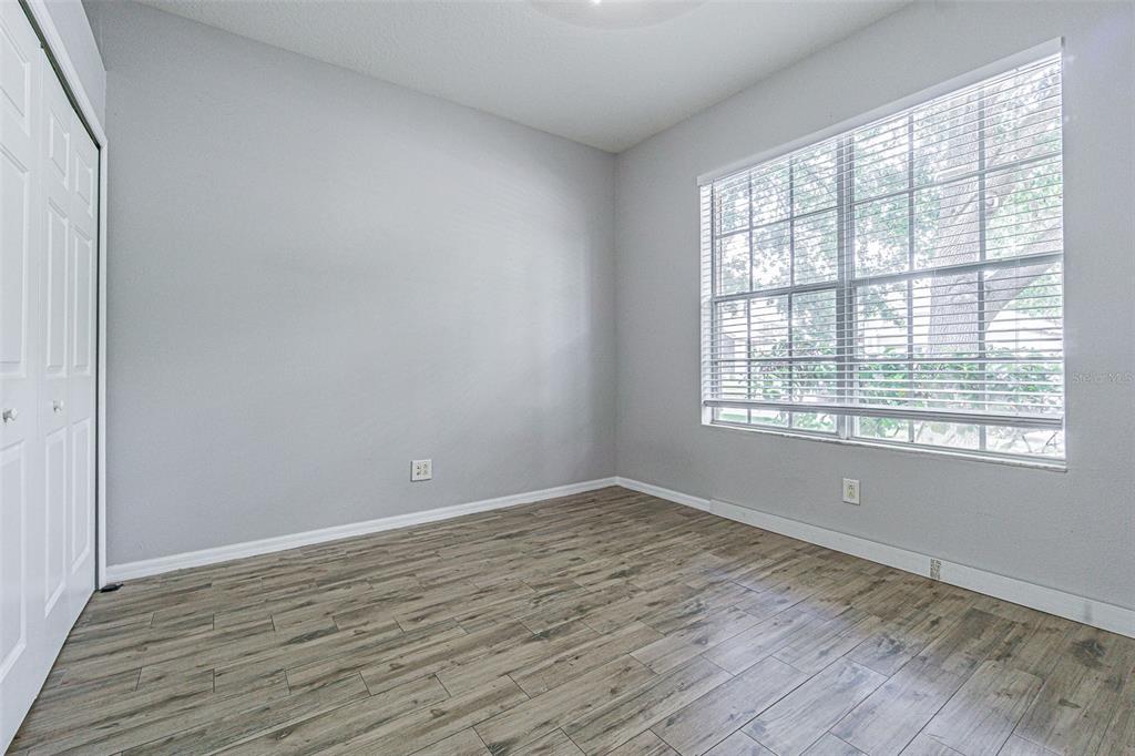 13016 Terrace Brook Place Temple Terrace, FL 33637 - Photo 13 of 27 wooden floor in an empty room with a window