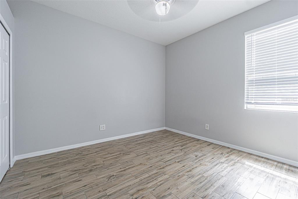 13016 Terrace Brook Place Temple Terrace, FL 33637 - Photo 14 of 27 a view of an empty room with wooden floor and a window