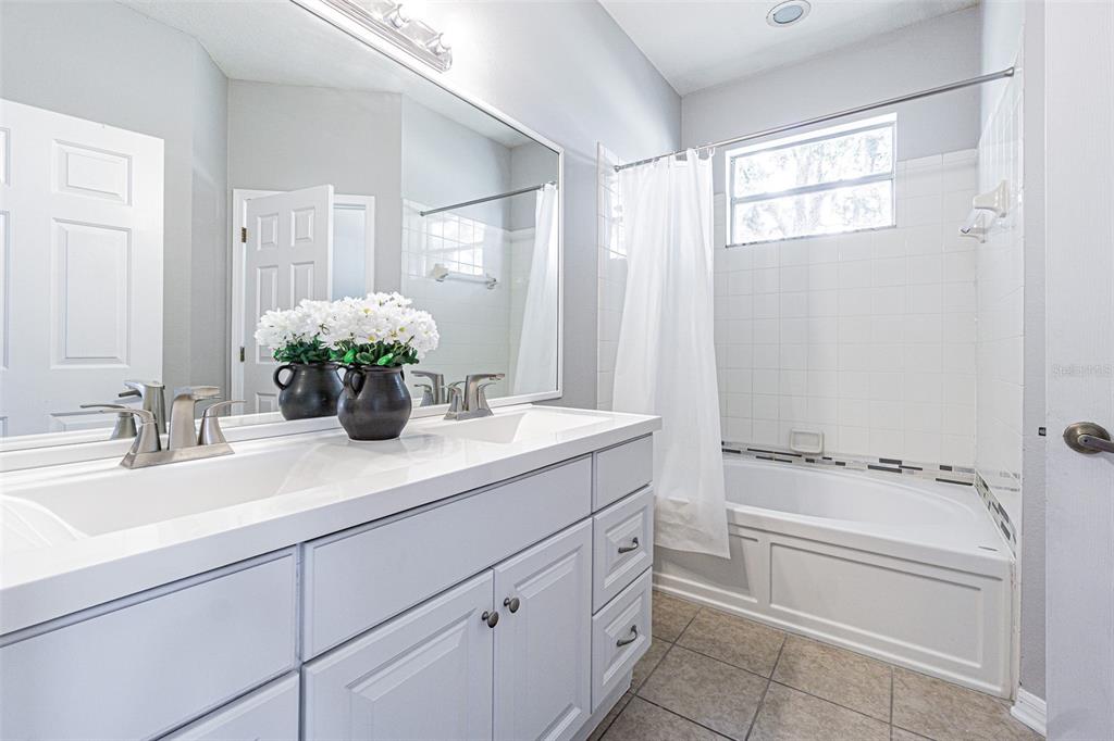13016 Terrace Brook Place Temple Terrace, FL 33637 - Photo 15 of 27 a bathroom with a tub sink and mirror