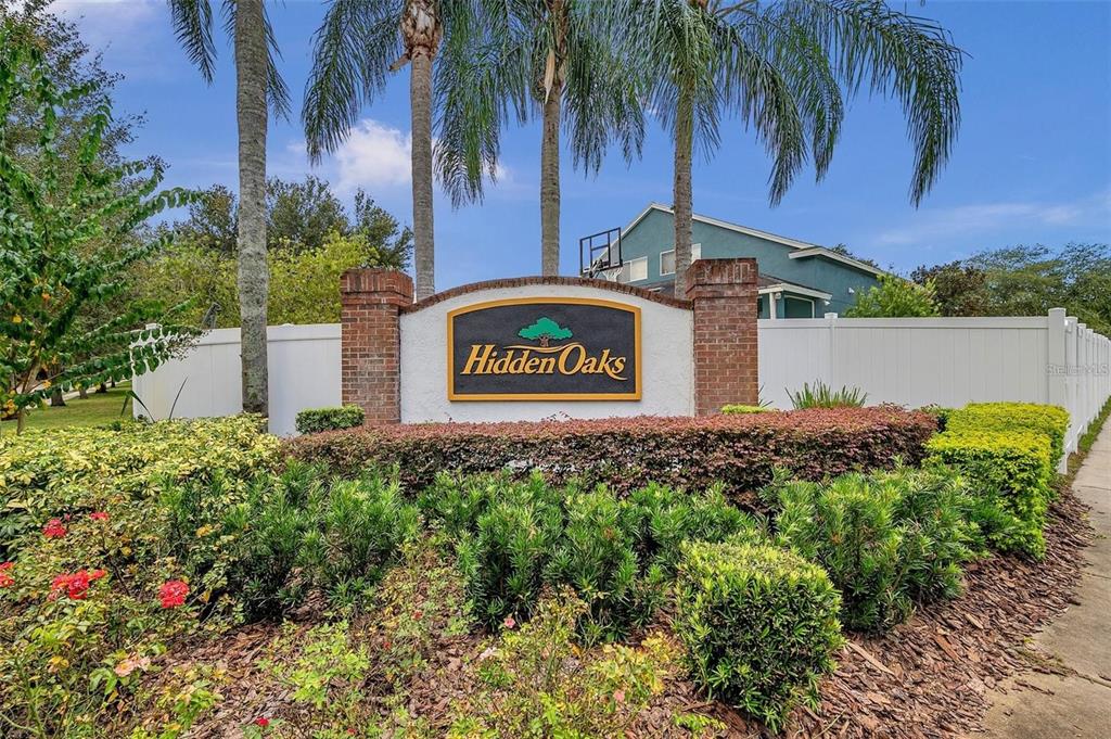 13016 Terrace Brook Place Temple Terrace, FL 33637 - Photo 26 of 27 a sign that is sitting in front of a house with a garden