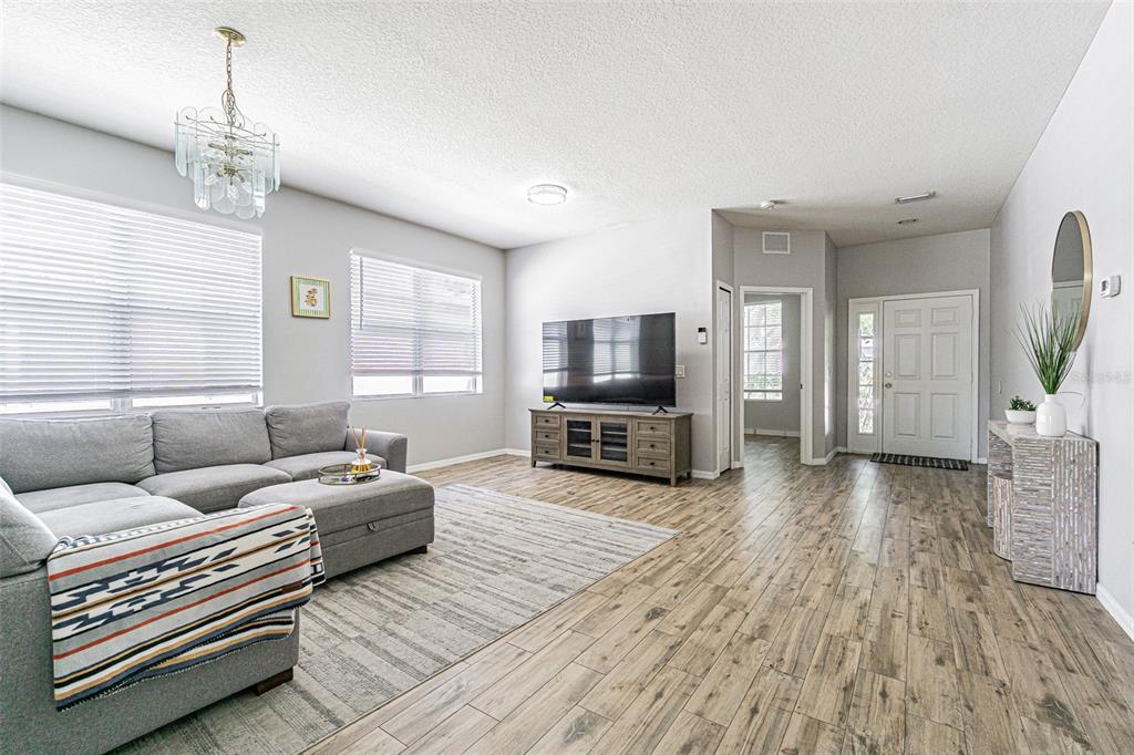 13016 Terrace Brook Place Temple Terrace, FL 33637 - Photo 3 of 27 a living room with furniture and a flat screen tv