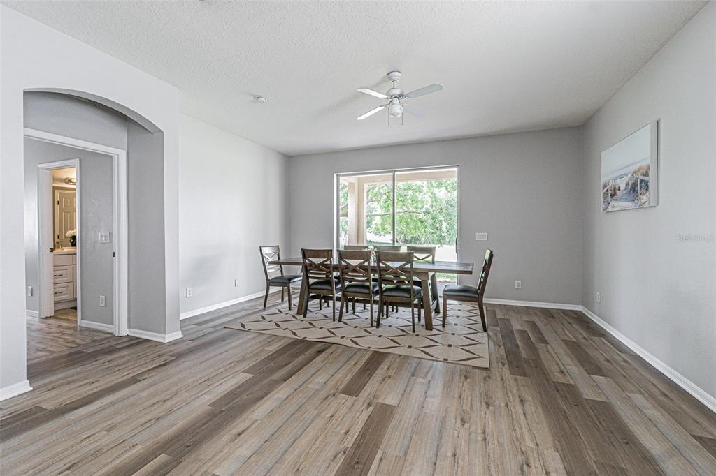 13016 Terrace Brook Place Temple Terrace, FL 33637 - Photo 8 of 27 a dining room with furniture and wooden floor