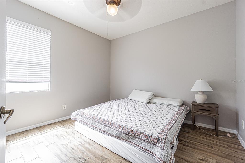 13016 Terrace Brook Place Temple Terrace, FL 33637 - Photo 10 of 27 a bedroom with a bed and a lamp