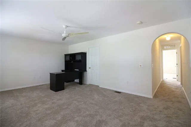 an empty room with closet and windows