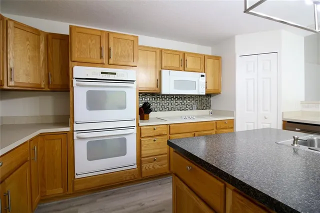 a kitchen with a stove a sink and a refrigerator