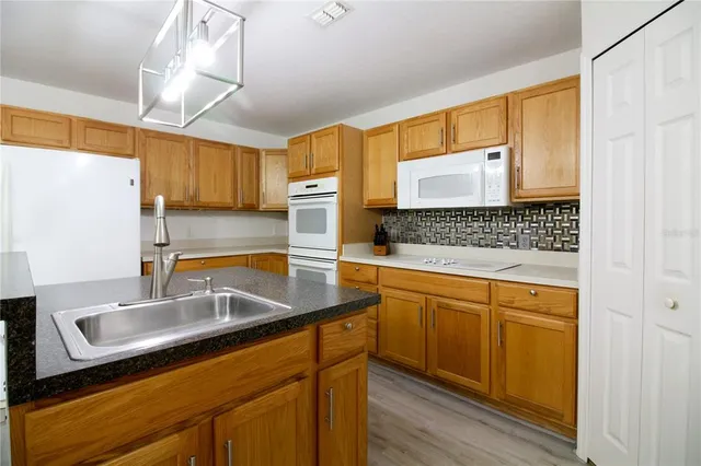 a kitchen with sink cabinets and window