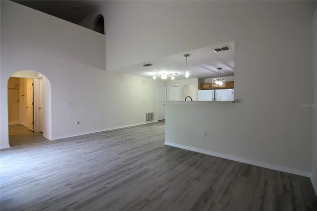 a view of a room with wooden floor and window