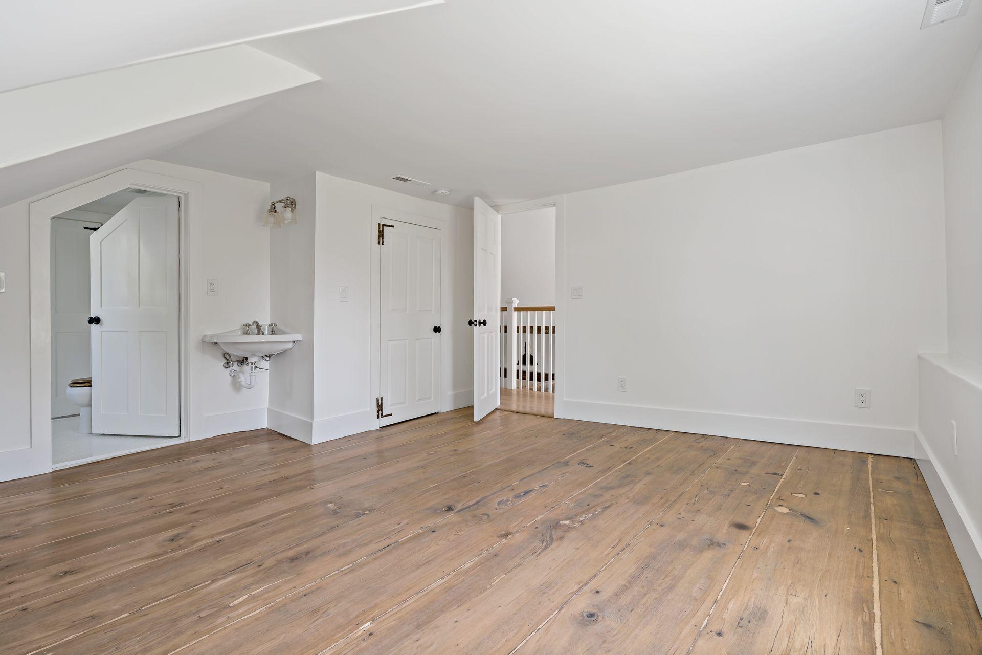 129 Davenport Ridge Road Stamford, CT 06903 - Photo 13 of 43 a view of an empty room with wooden floor and a window