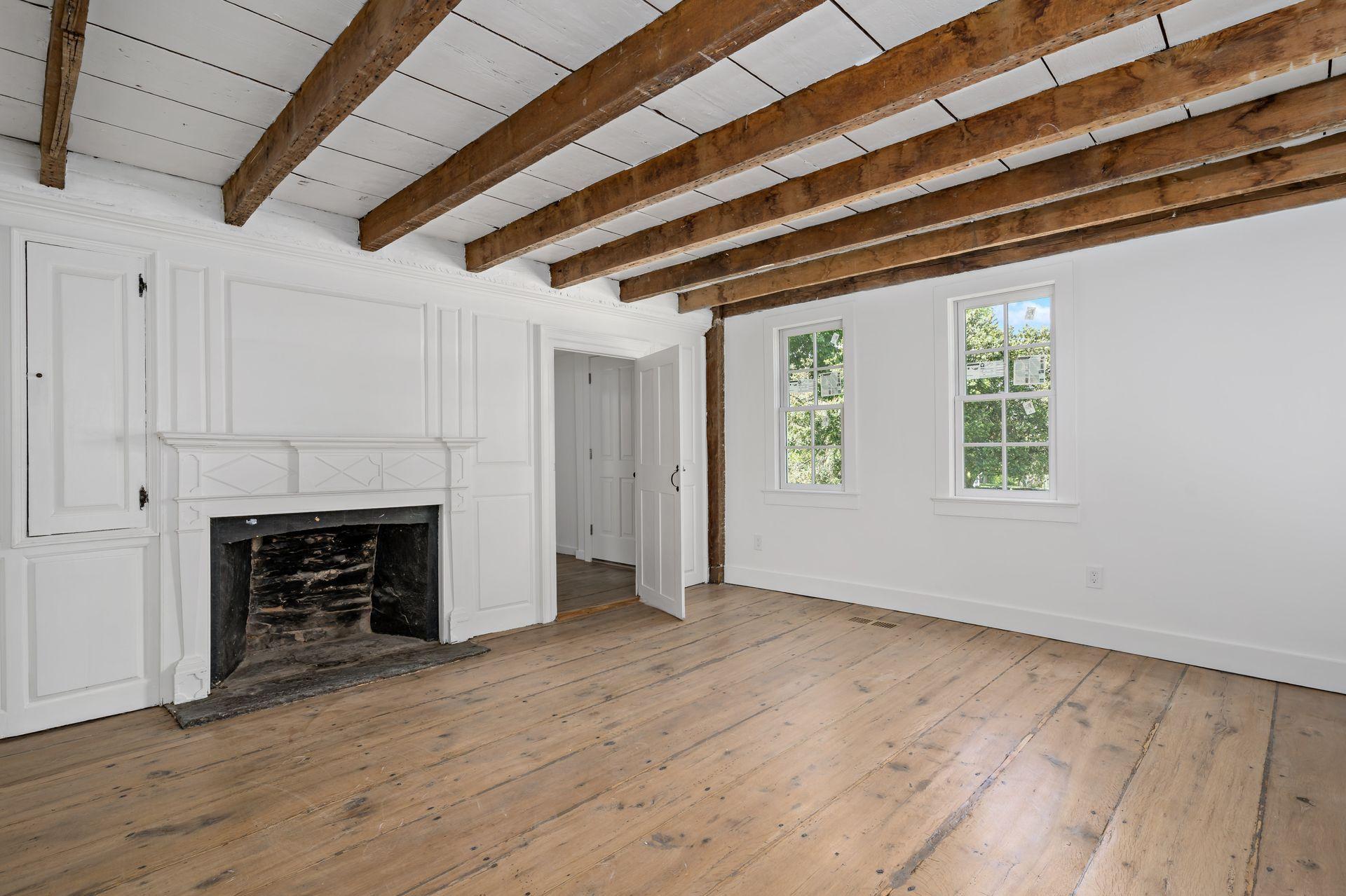 129 Davenport Ridge Road Stamford, CT 06903 - Photo 21 of 43 a view of an empty room with wooden floor fireplace and a window