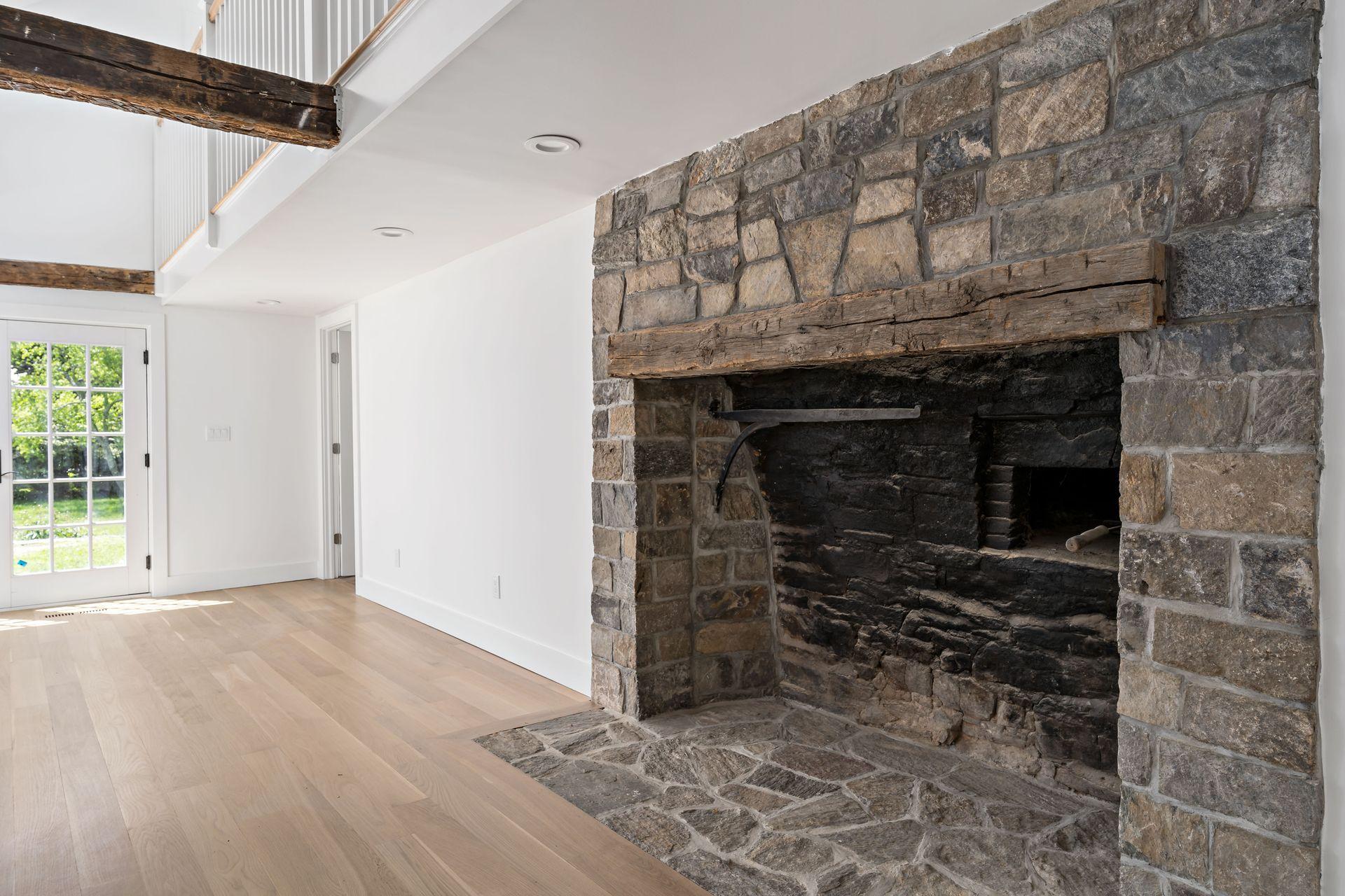 129 Davenport Ridge Road Stamford, CT 06903 - Photo 22 of 43 a view of an empty room with wooden floor and a fireplace