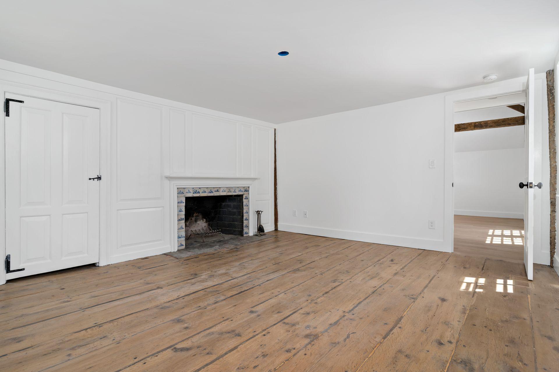 129 Davenport Ridge Road Stamford, CT 06903 - Photo 24 of 43 a view of an empty room with wooden floor and a fireplace