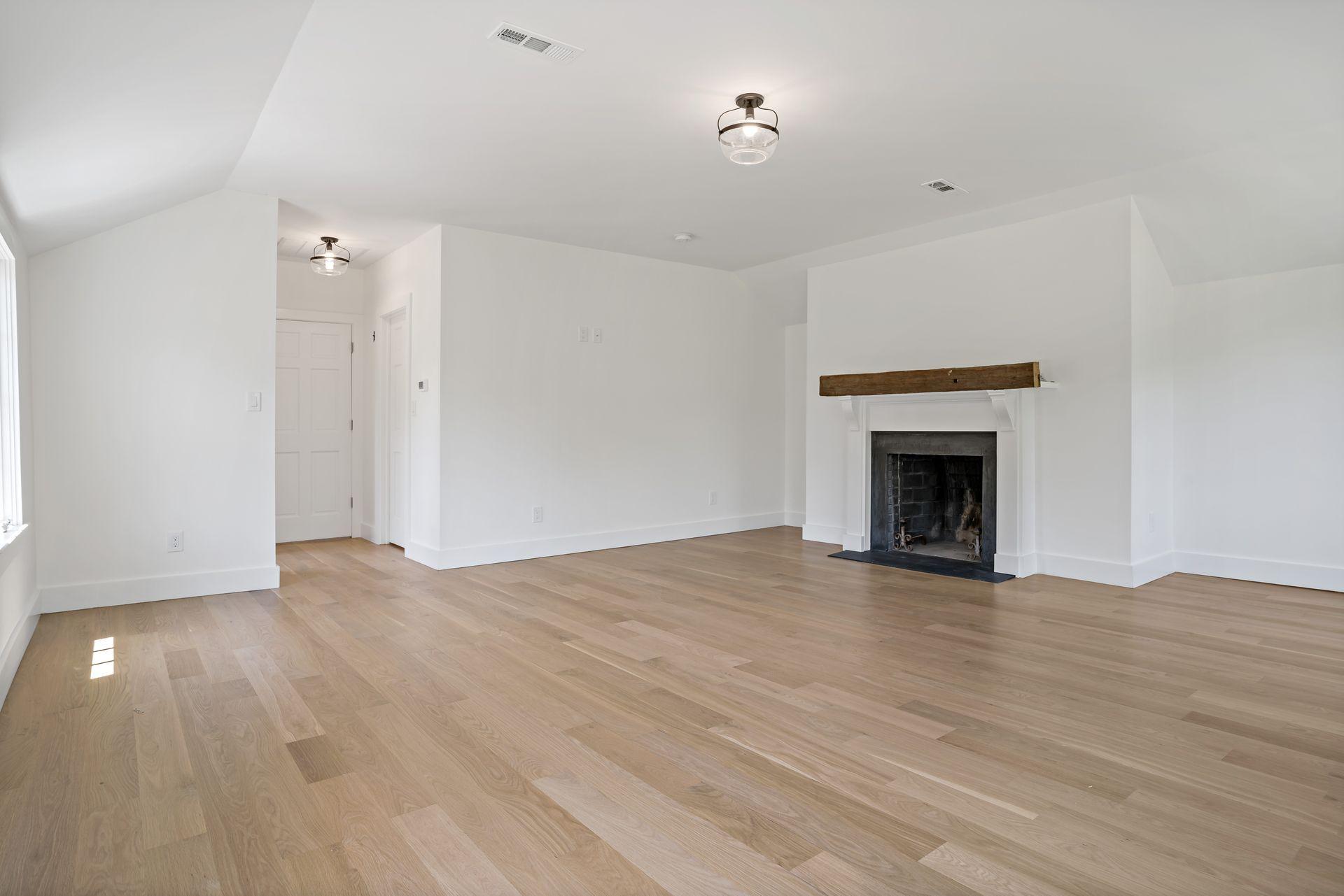 129 Davenport Ridge Road Stamford, CT 06903 - Photo 26 of 43 a view of empty room with wooden floor and fireplace