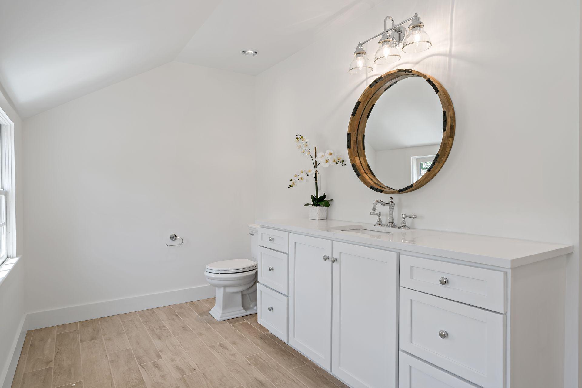 129 Davenport Ridge Road Stamford, CT 06903 - Photo 28 of 43 a bathroom with a toilet a sink and a mirror