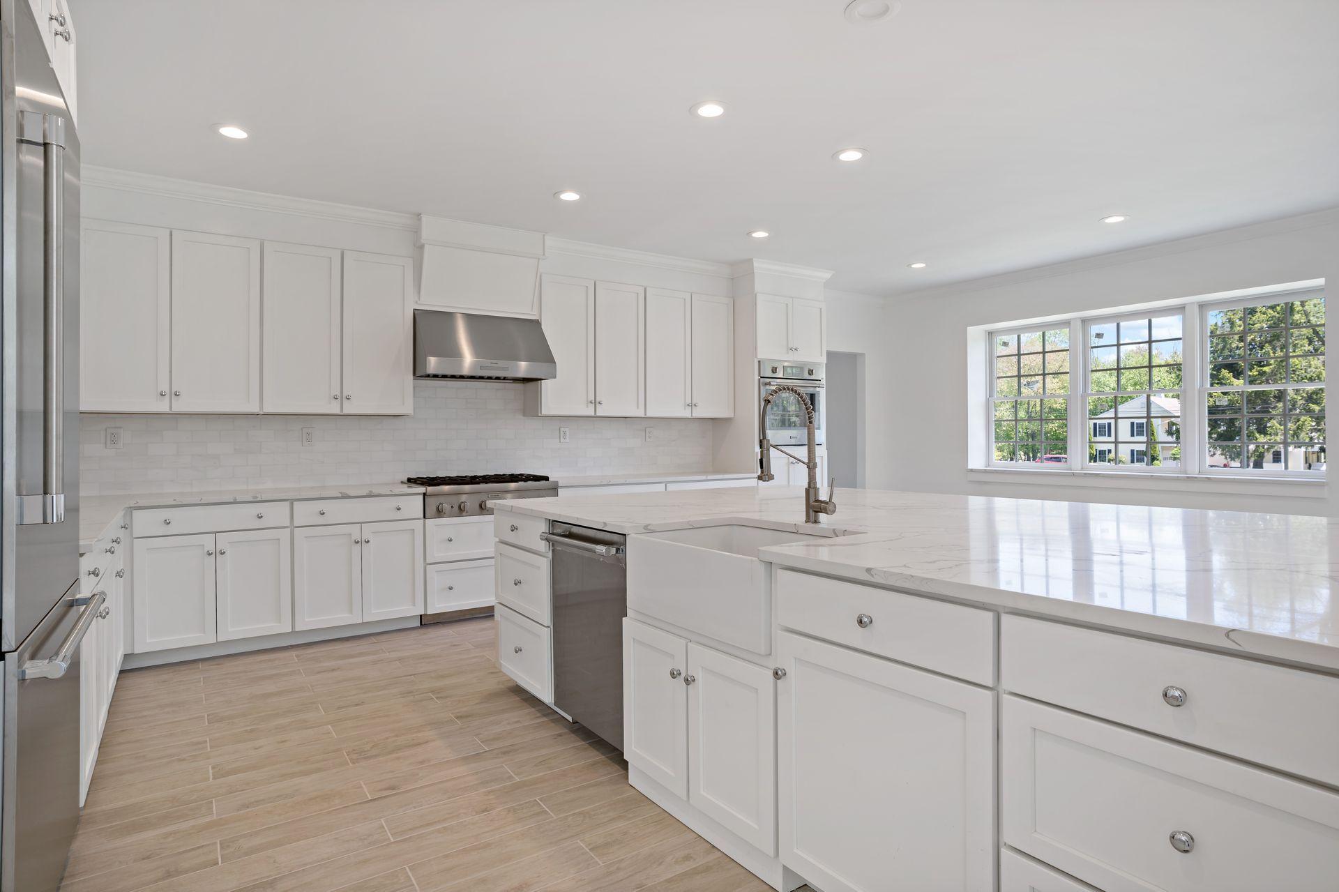 129 Davenport Ridge Road Stamford, CT 06903 - Photo 32 of 43 a kitchen with white cabinets and window