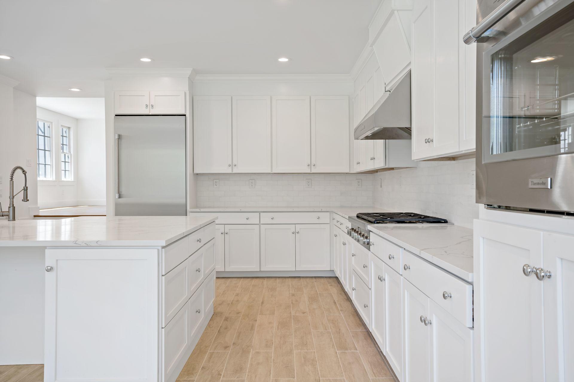 129 Davenport Ridge Road Stamford, CT 06903 - Photo 34 of 43 a kitchen with granite countertop white cabinets and white appliances