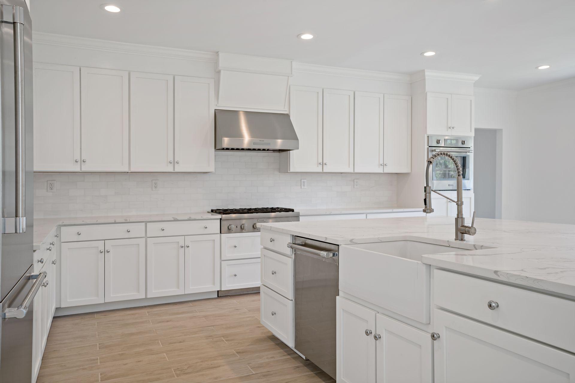 129 Davenport Ridge Road Stamford, CT 06903 - Photo 35 of 43 a kitchen with white cabinets appliances and a sink
