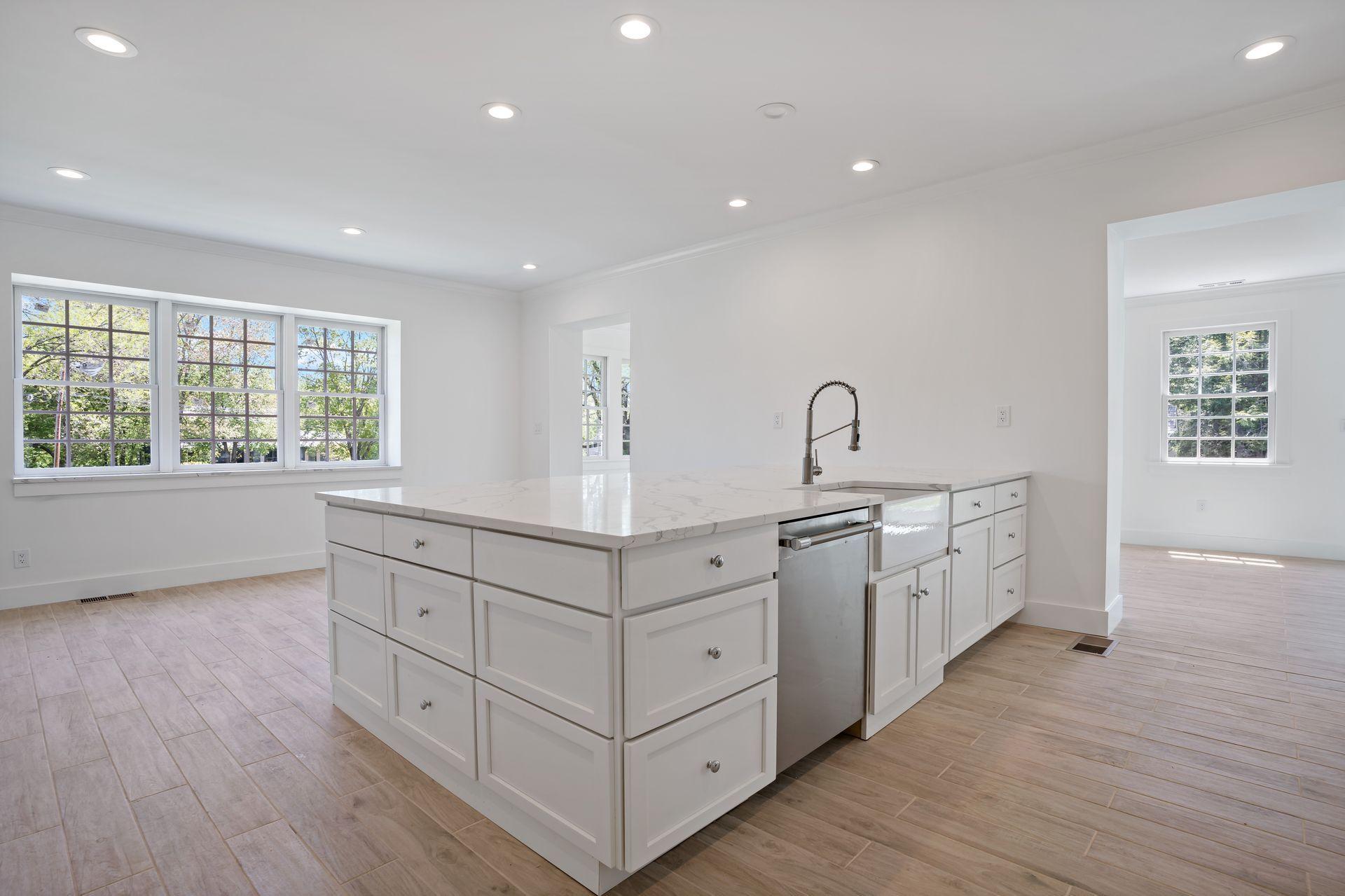 129 Davenport Ridge Road Stamford, CT 06903 - Photo 36 of 43 a kitchen with granite countertop white cabinets and wooden floors