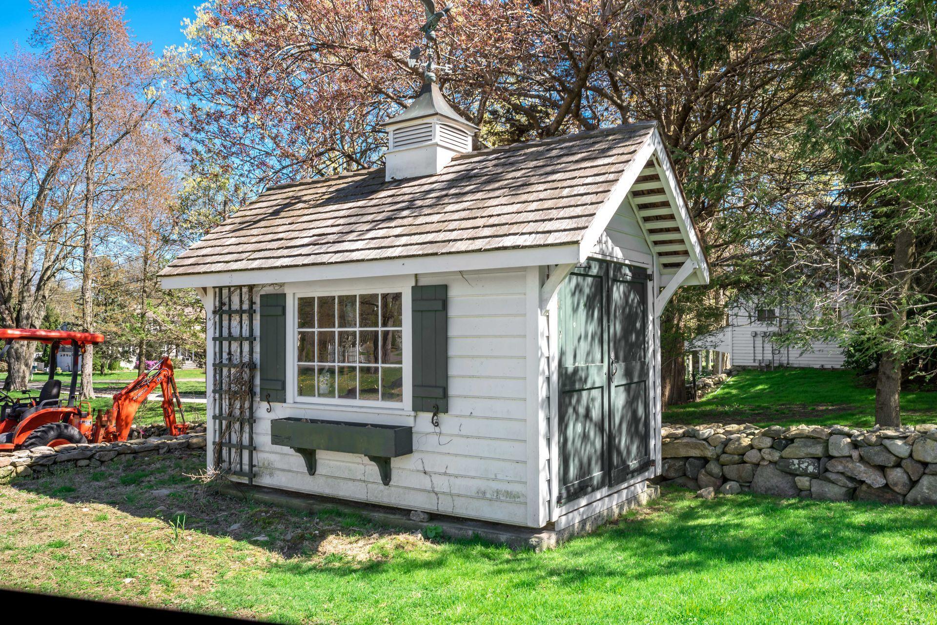 129 Davenport Ridge Road Stamford, CT 06903 - Photo 40 of 43 a view of a house with a yard and potted plants