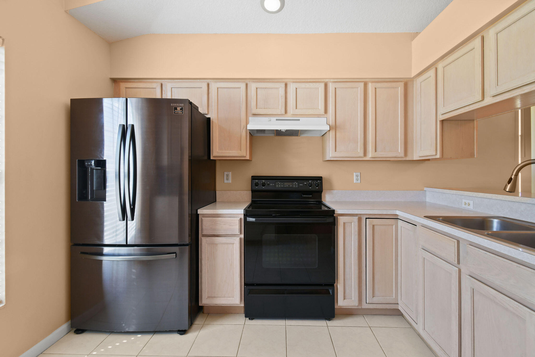 6293 Michael Street Jupiter, FL 33458 - Photo 13 of 64 a kitchen with stainless steel appliances a refrigerator sink and cabinets