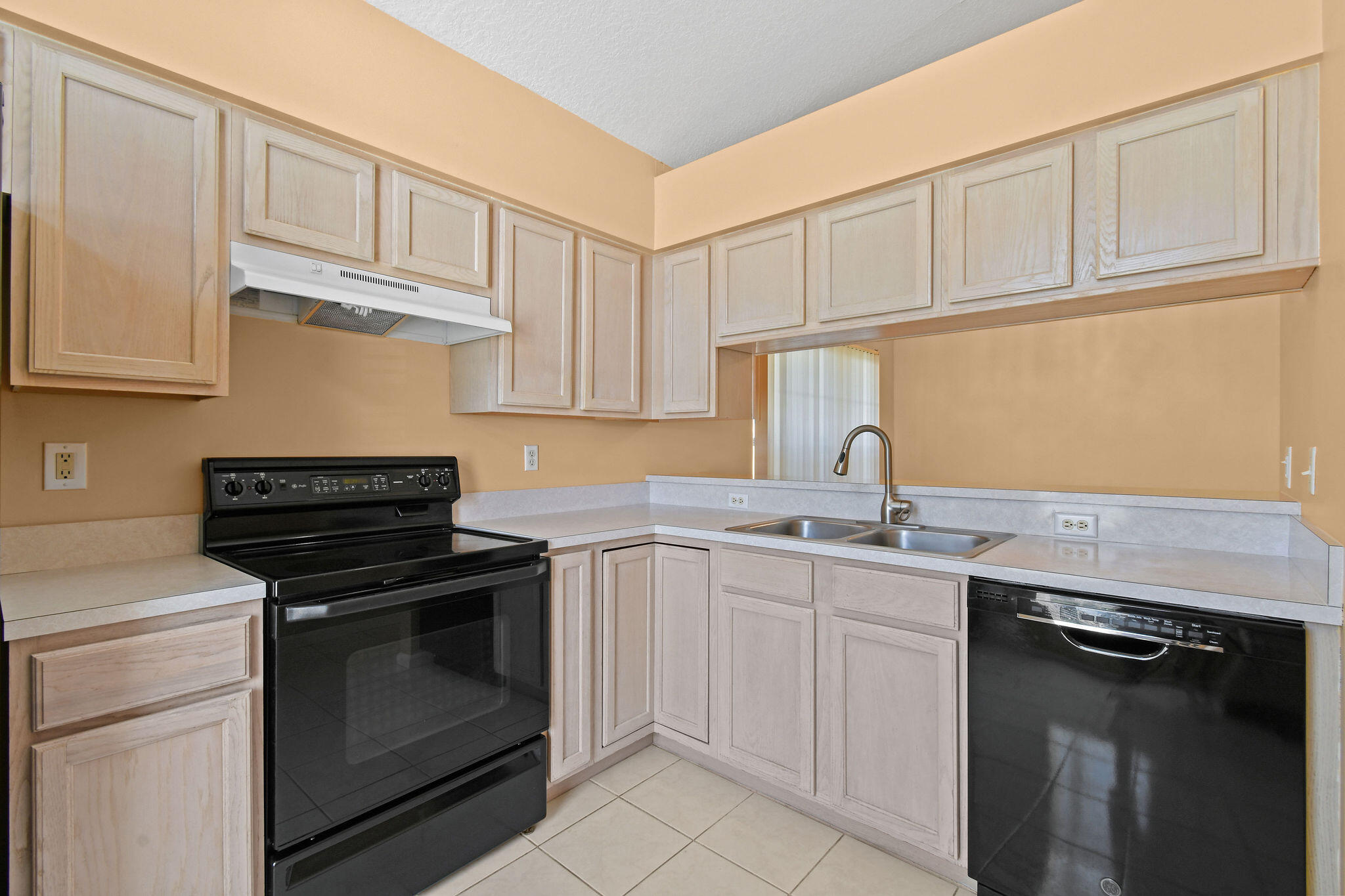 6293 Michael Street Jupiter, FL 33458 - Photo 14 of 64 a kitchen with white cabinets stainless steel appliances and sink