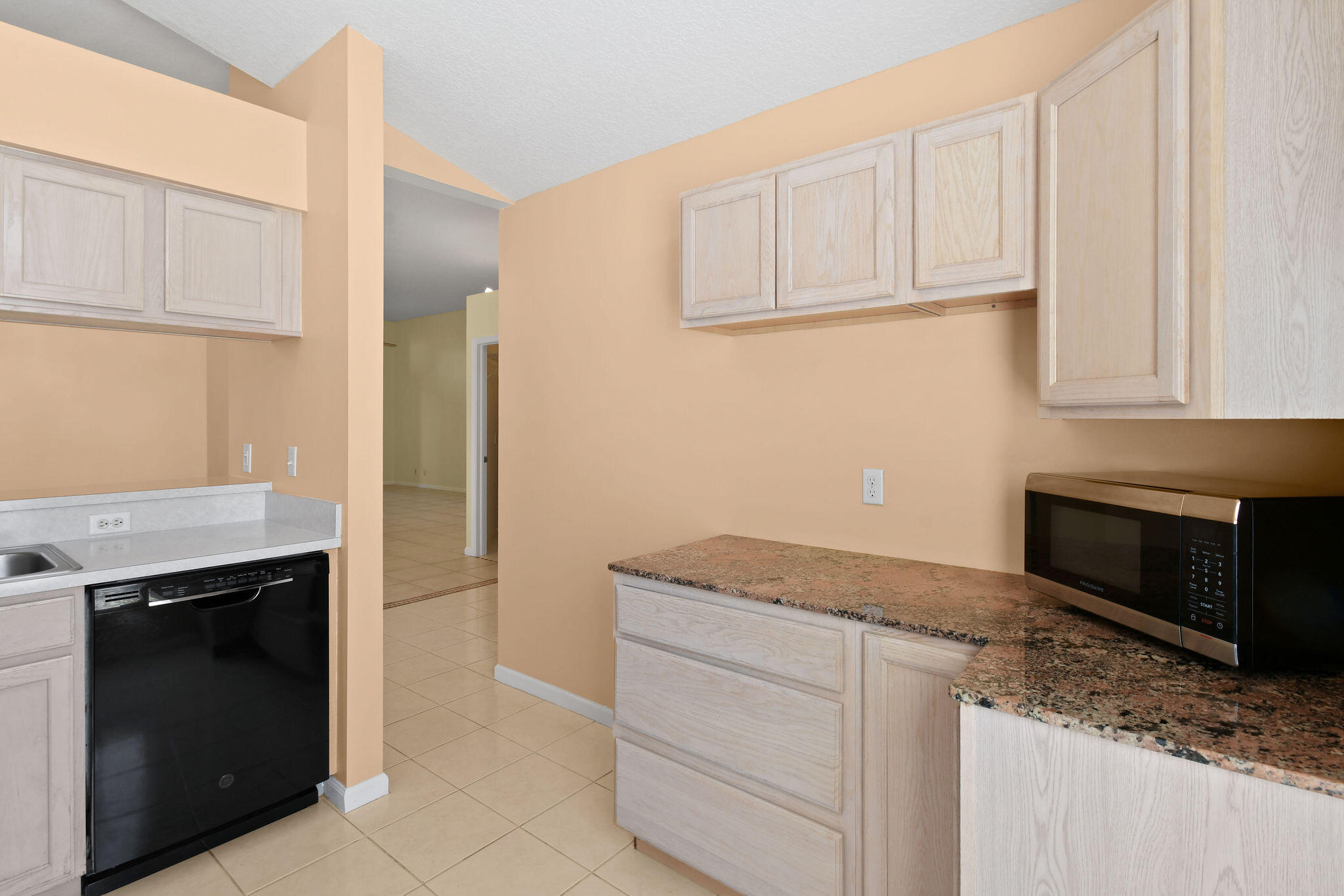 6293 Michael Street Jupiter, FL 33458 - Photo 15 of 64 a kitchen with granite countertop white cabinets and stainless steel appliances