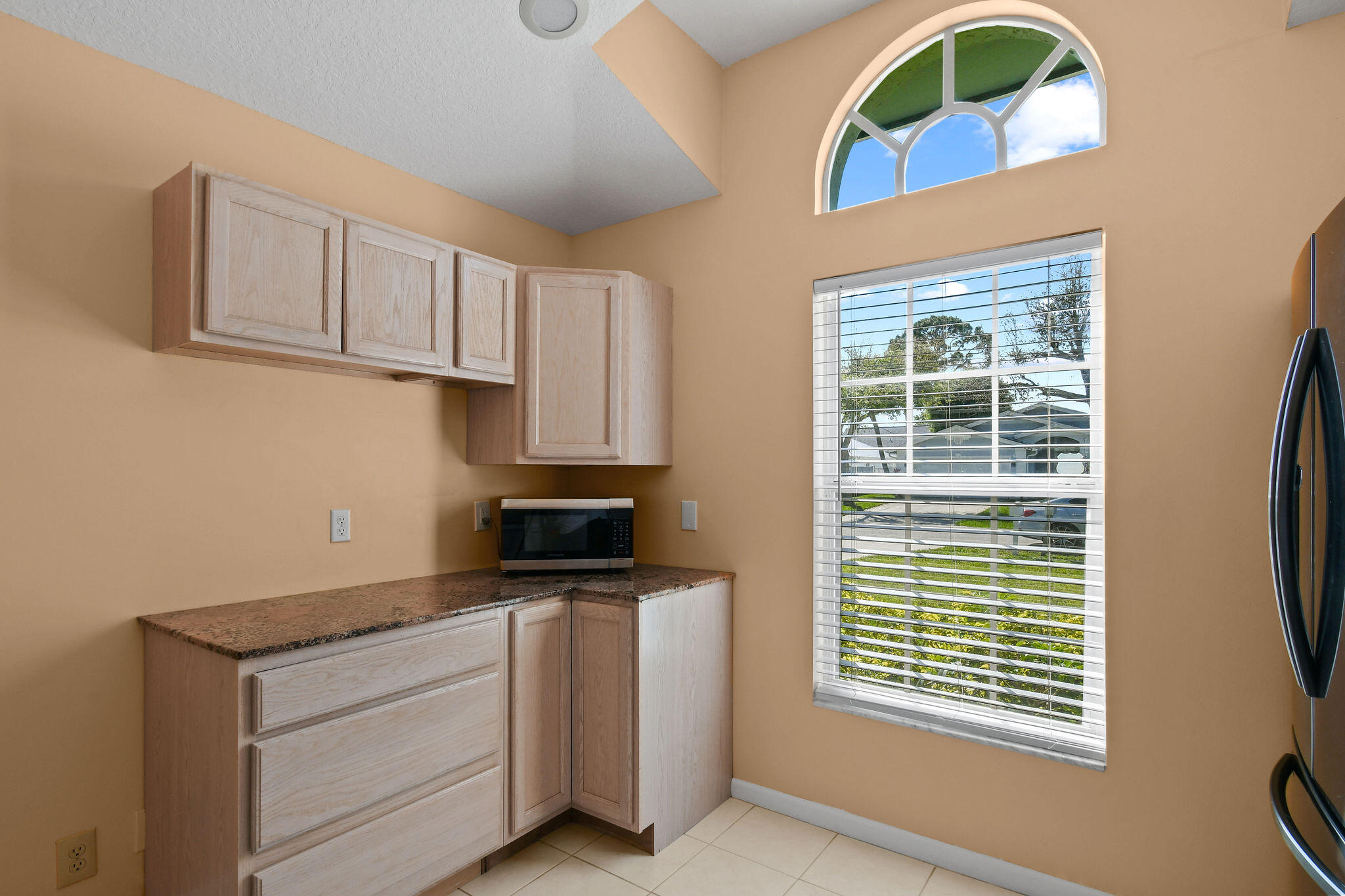 6293 Michael Street Jupiter, FL 33458 - Photo 16 of 64 a kitchen with stainless steel appliances granite countertop a stove a sink and a window