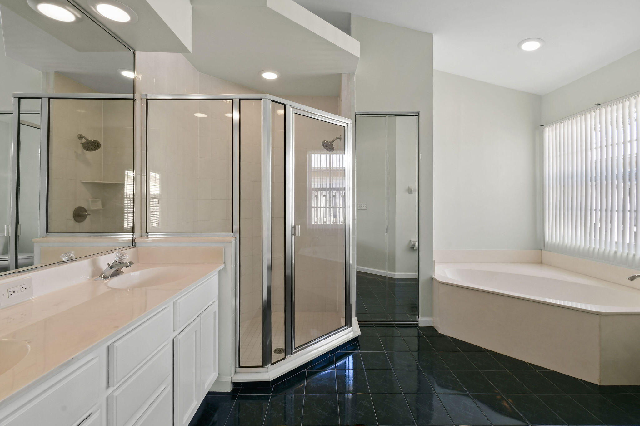 6293 Michael Street Jupiter, FL 33458 - Photo 25 of 64 a bathroom with a double vanity sink mirror and shower