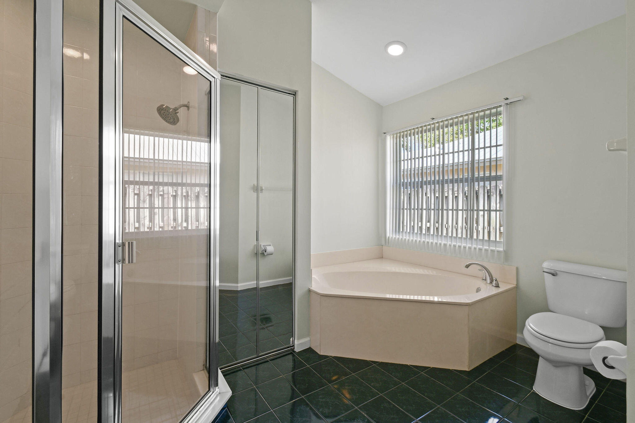 6293 Michael Street Jupiter, FL 33458 - Photo 28 of 64 a bathroom with a white bath tub a toilet and a sink