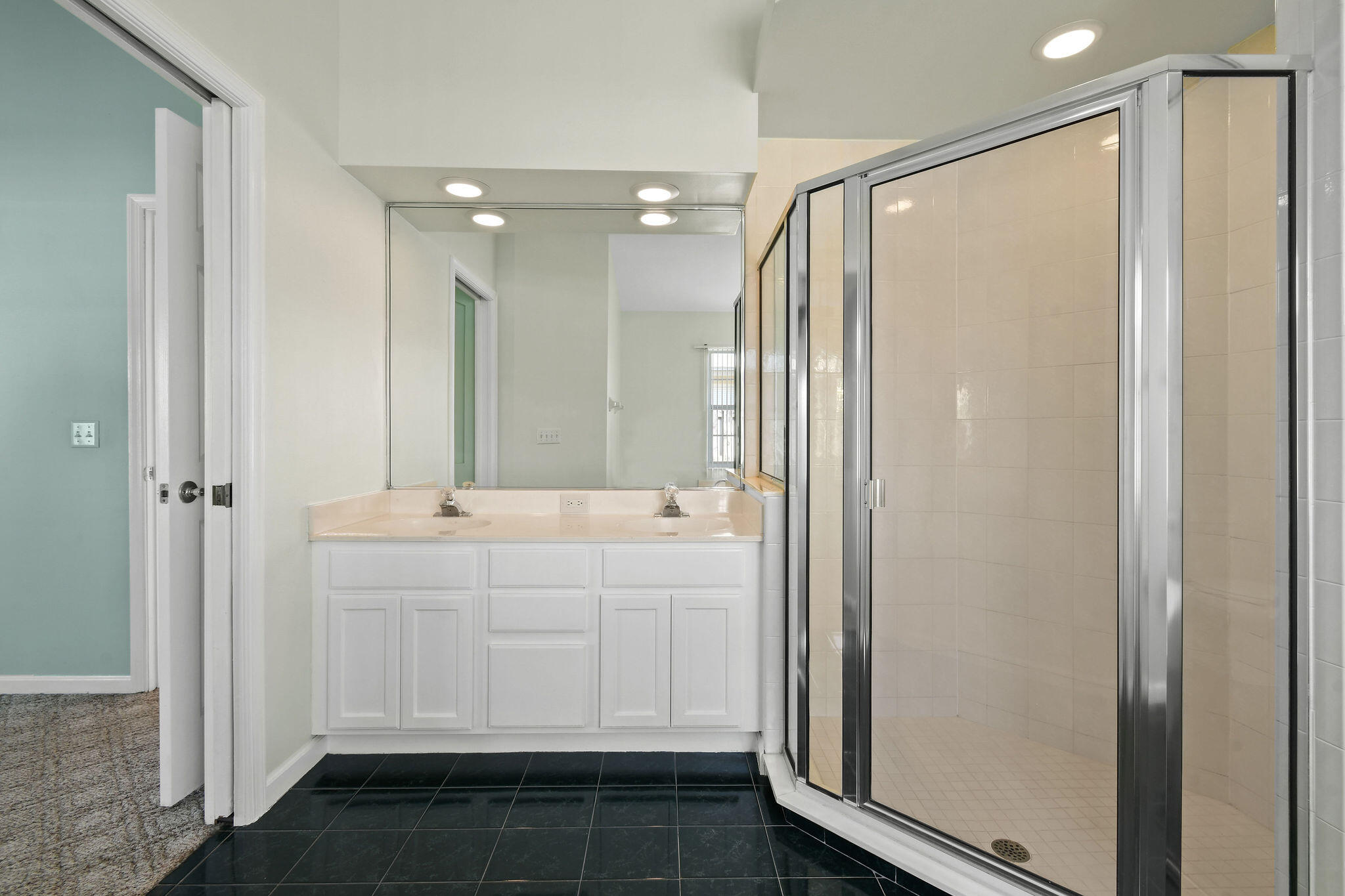 6293 Michael Street Jupiter, FL 33458 - Photo 29 of 64 a bathroom with a mirror a double vanity sink and glass door