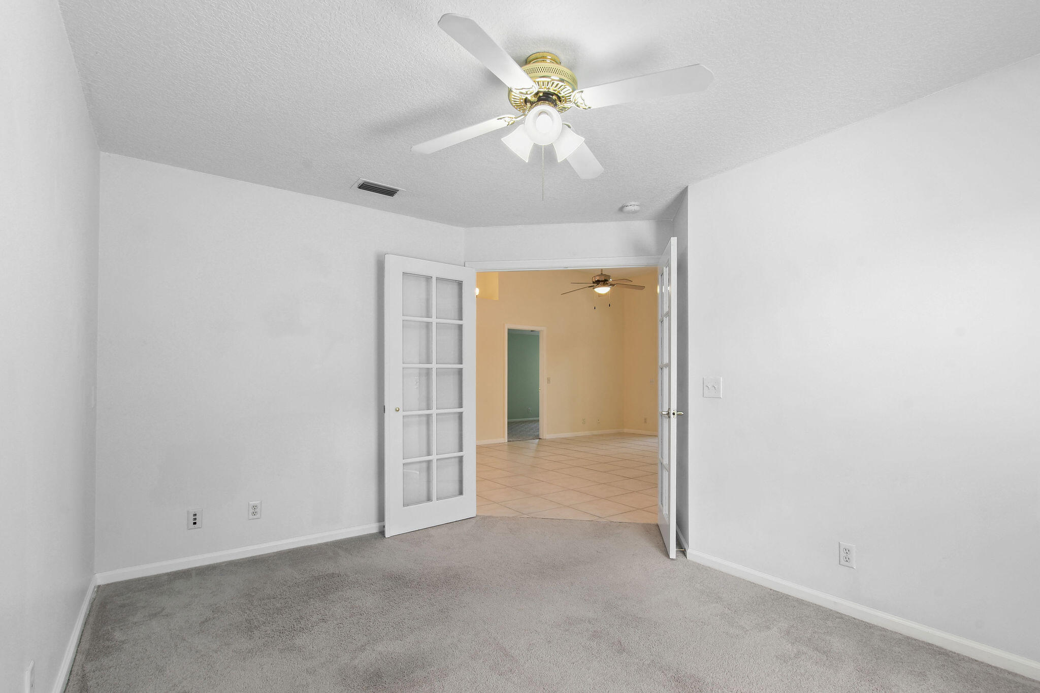 6293 Michael Street Jupiter, FL 33458 - Photo 32 of 64 an empty room with fan and a ceiling fan