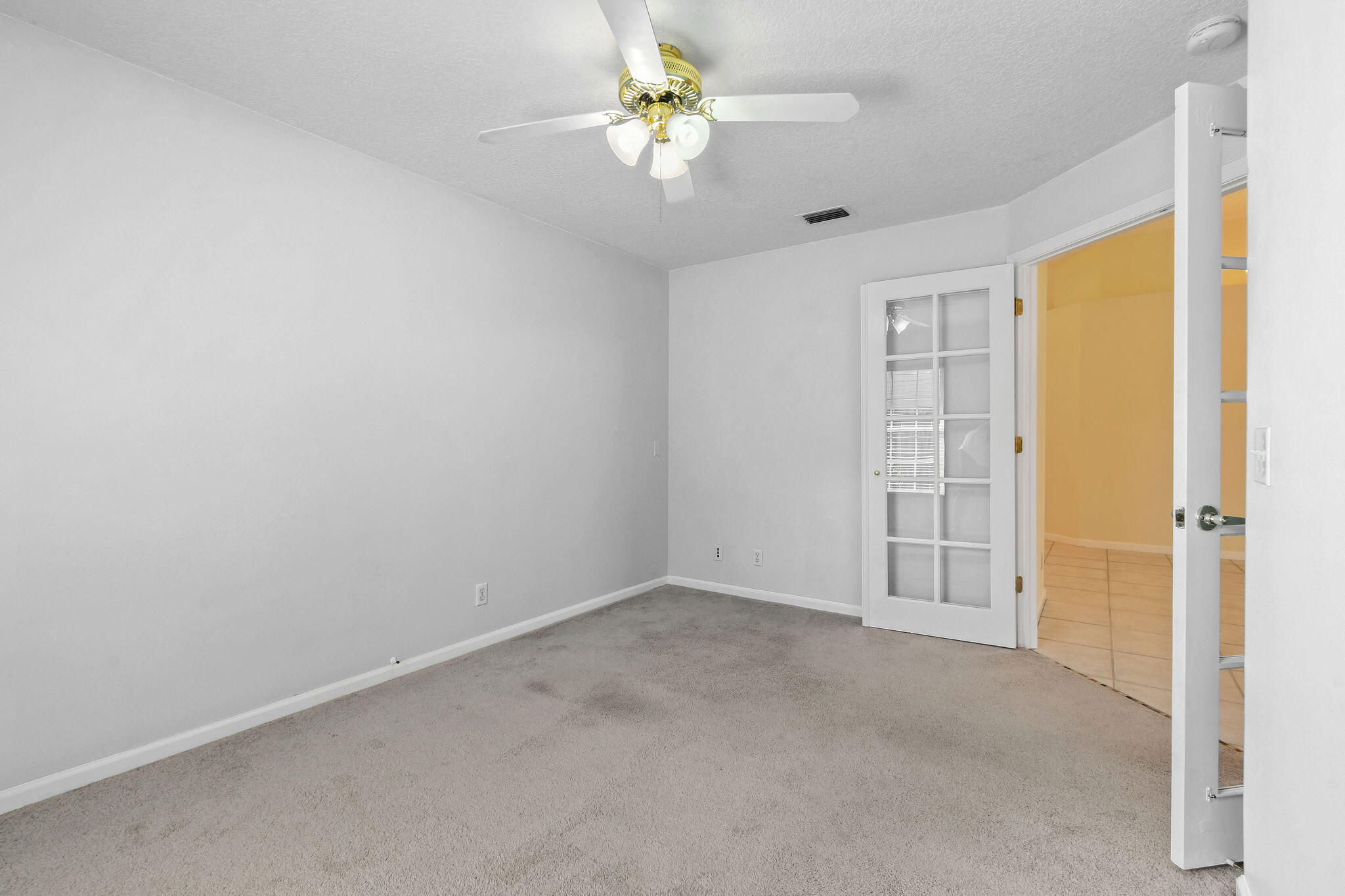 6293 Michael Street Jupiter, FL 33458 - Photo 33 of 64 an empty room with windows and fan