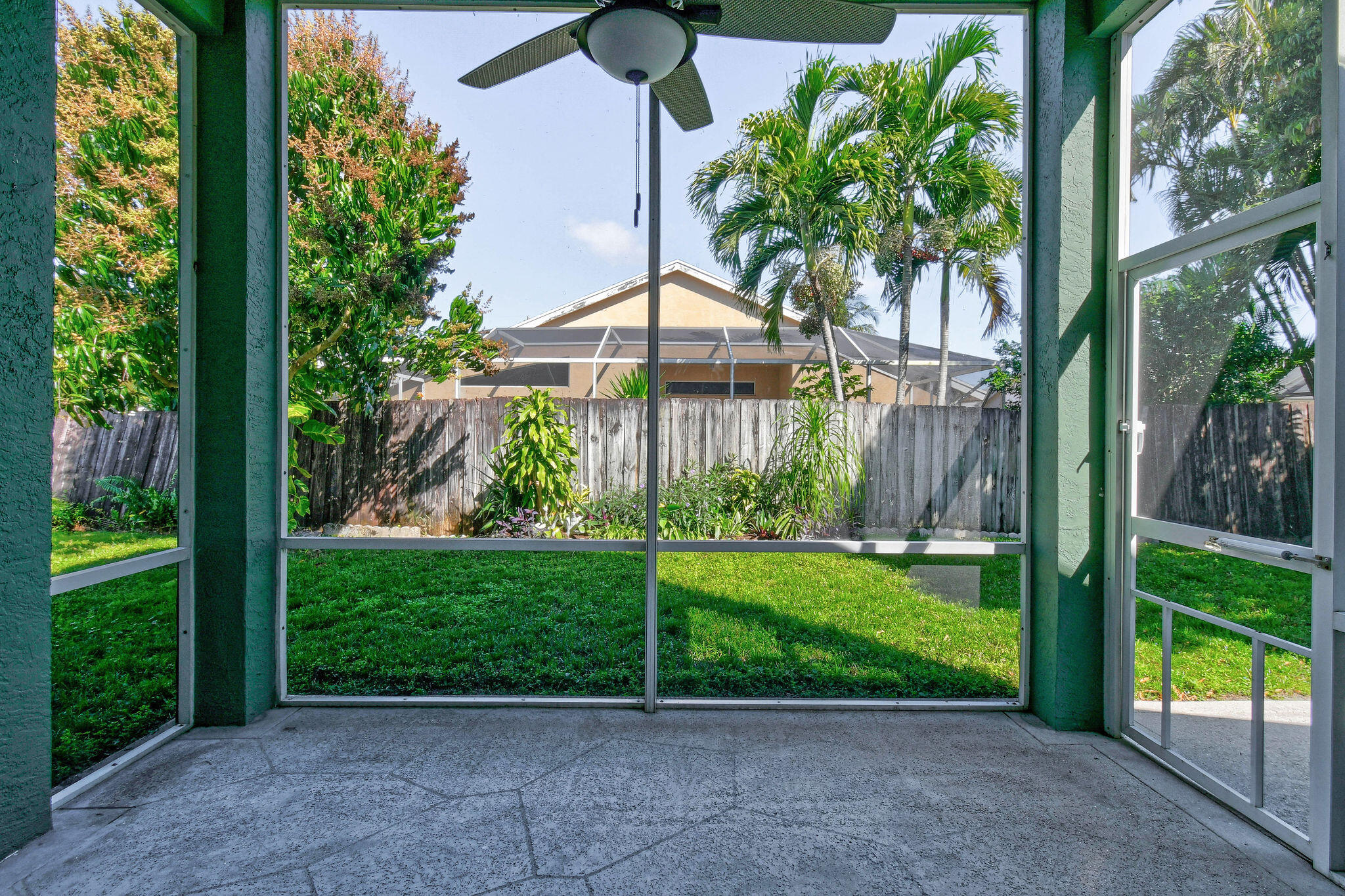 6293 Michael Street Jupiter, FL 33458 - Photo 38 of 64 a front view of a house with a yard and potted plants