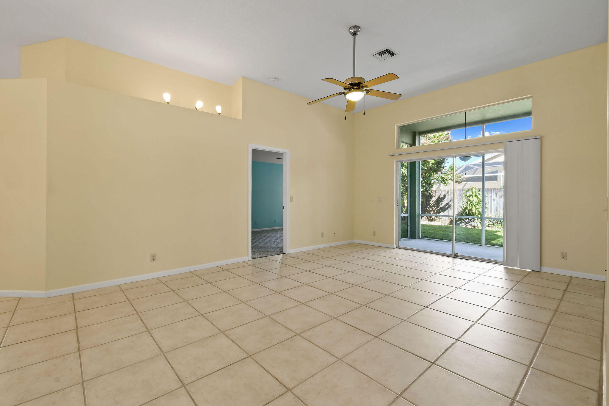 6293 Michael Street Jupiter, FL 33458 - Photo 5 of 64 a view of an empty room and window chandelier fan