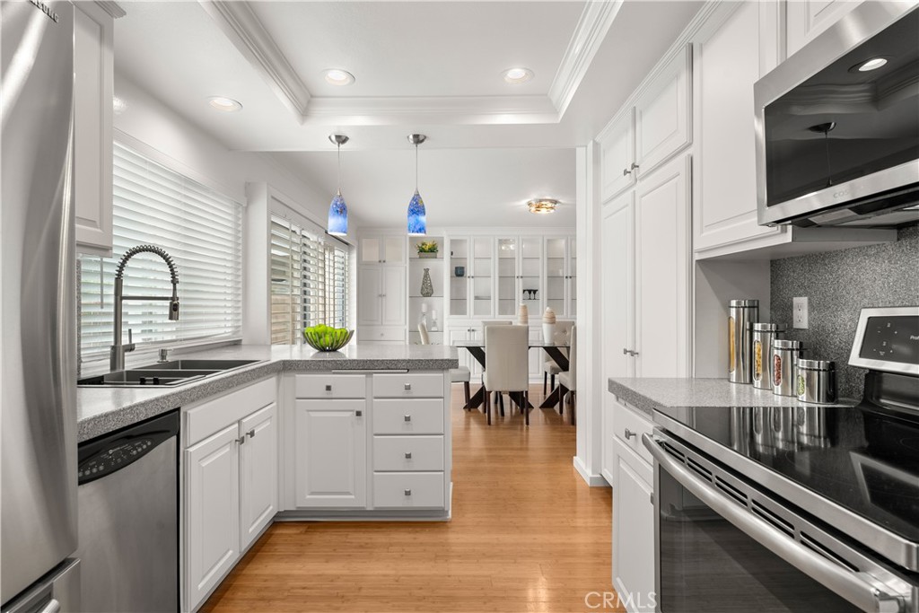 1872 Parkview Circle Costa Mesa, CA 92627 - Photo 13 of 49 a kitchen with stainless steel appliances sink stove microwave and cabinets