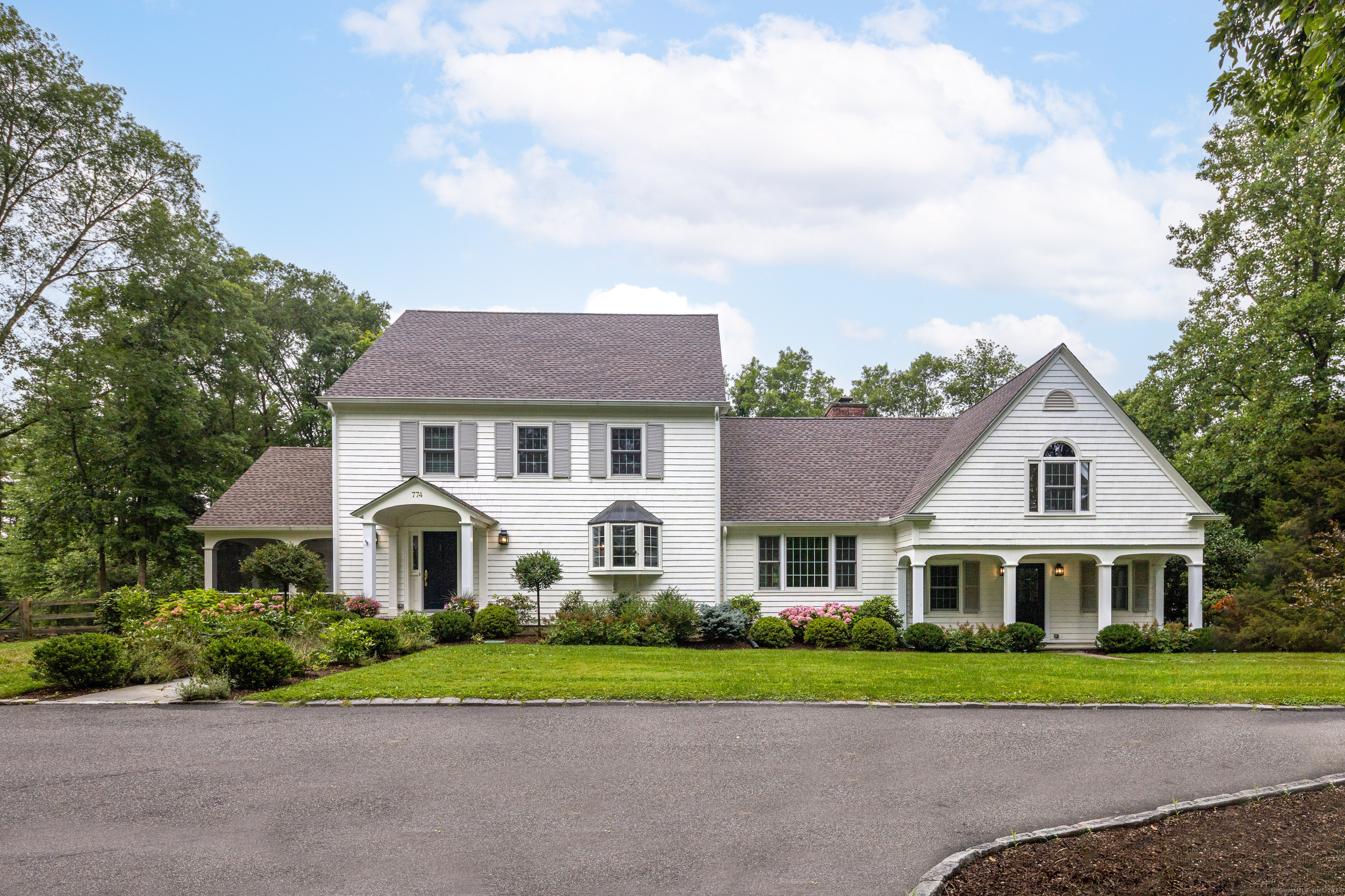 774 Oenoke Ridge New Canaan, CT 06840 - Photo 1 of 1 a front view of a house with a yard