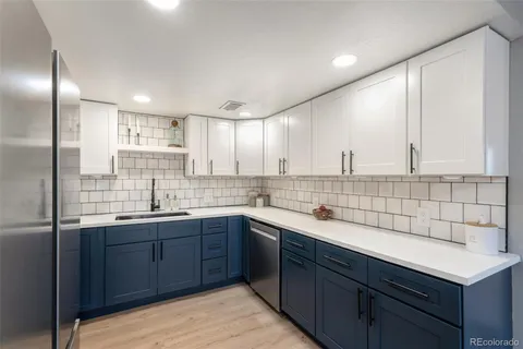 a kitchen with a sink window and cabinets