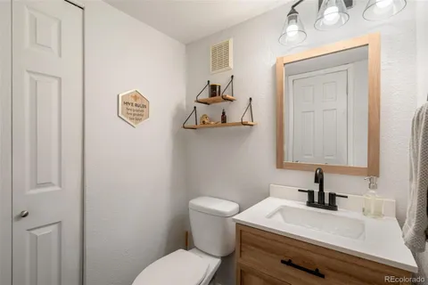a white toilet sitting next to a bathroom sink