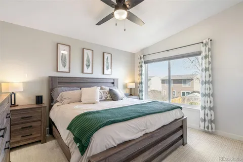 a bedroom with a bed and a large window