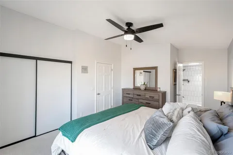 a bedroom with a bed and dresser with mirror