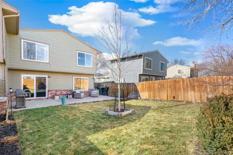 a view of a house with backyard porch and sitting area