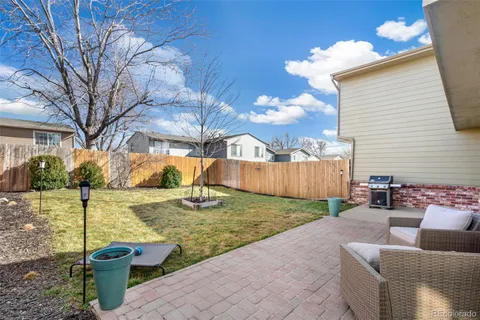 a view of a backyard with sitting area