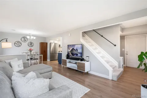 a living room with furniture and a potted plant