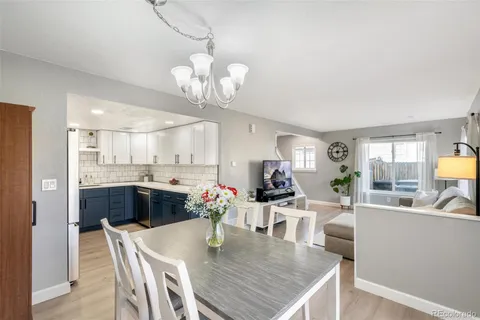 a view of a dining room with furniture and chandelier