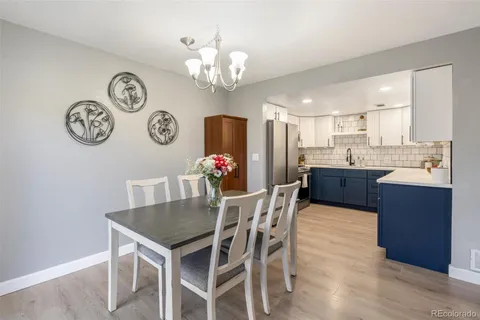 a view of a dining room with furniture and kitchen view