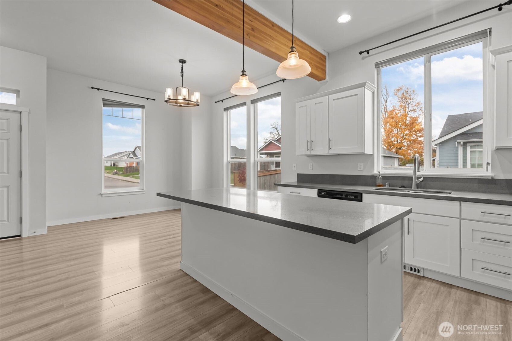 708 Miller Street Winlock, WA 98596 - Photo 12 of 40 a kitchen with stainless steel appliances granite countertop a sink a microwave cabinets and a large window