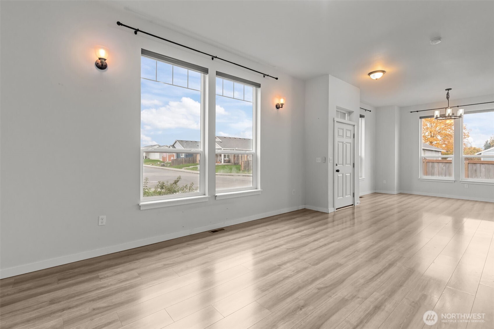 708 Miller Street Winlock, WA 98596 - Photo 4 of 40 a view of an empty room with a window and wooden floor