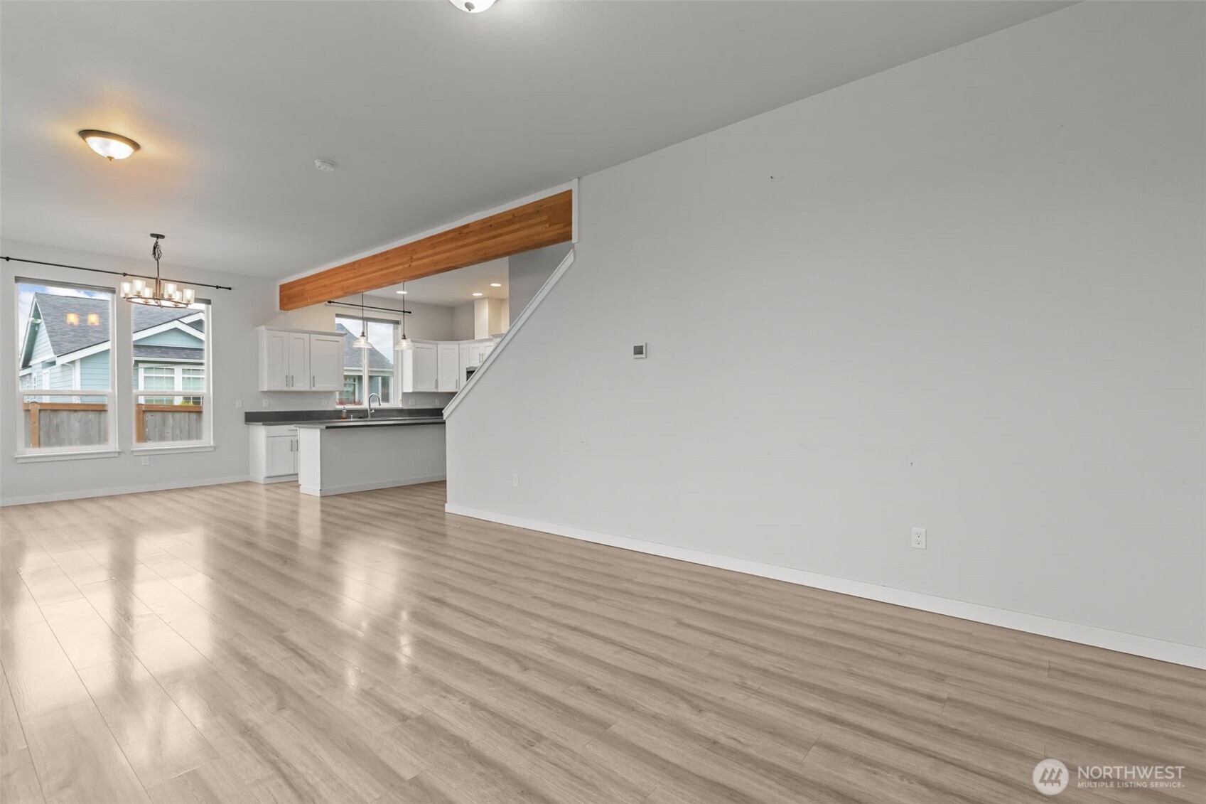 708 Miller Street Winlock, WA 98596 - Photo 5 of 40 a view of empty room with wooden floor and kitchen