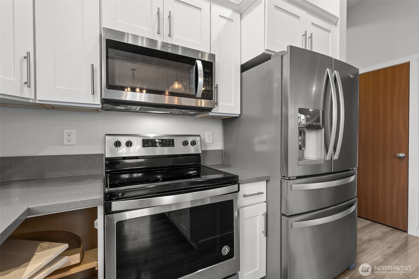 708 Miller Street Winlock, WA 98596 - Photo 10 of 40 a kitchen with stainless steel appliances and wooden cabinets