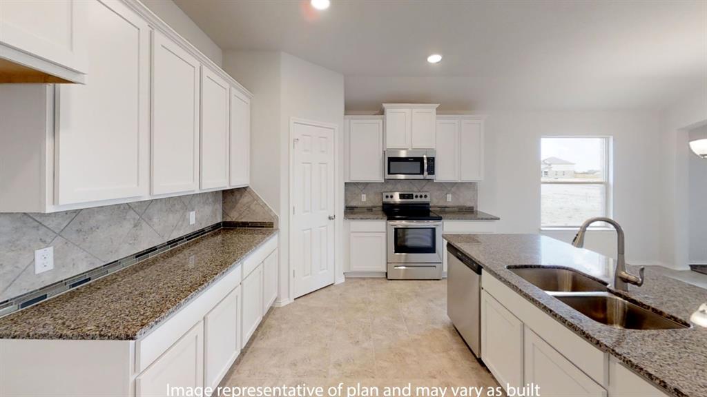 5800 Foggy Lagoon Drive Waco, TX 76708 - Photo 10 of 24 a kitchen with kitchen island granite countertop a sink and white cabinets